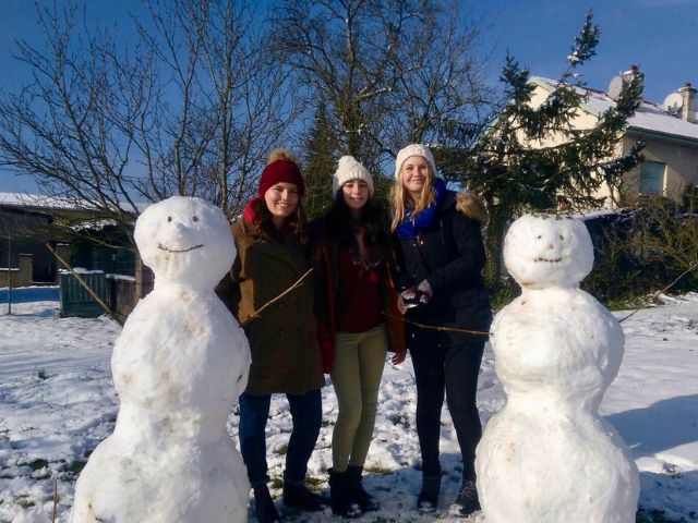 Host siblings with snow people in France