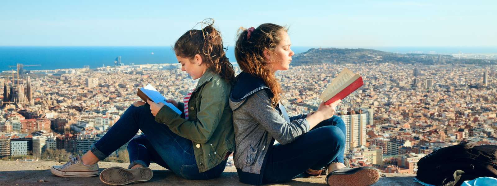 Two girls reading at lookout in Barcelona
